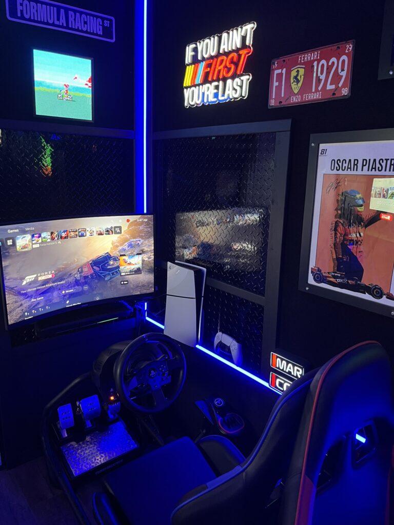 (1) Realistic Racing Simulator equipped with a PS5, 32″ LED Gaming Monitor, adjustable racing seat, steering wheel gear shift, and pedals ready to race!